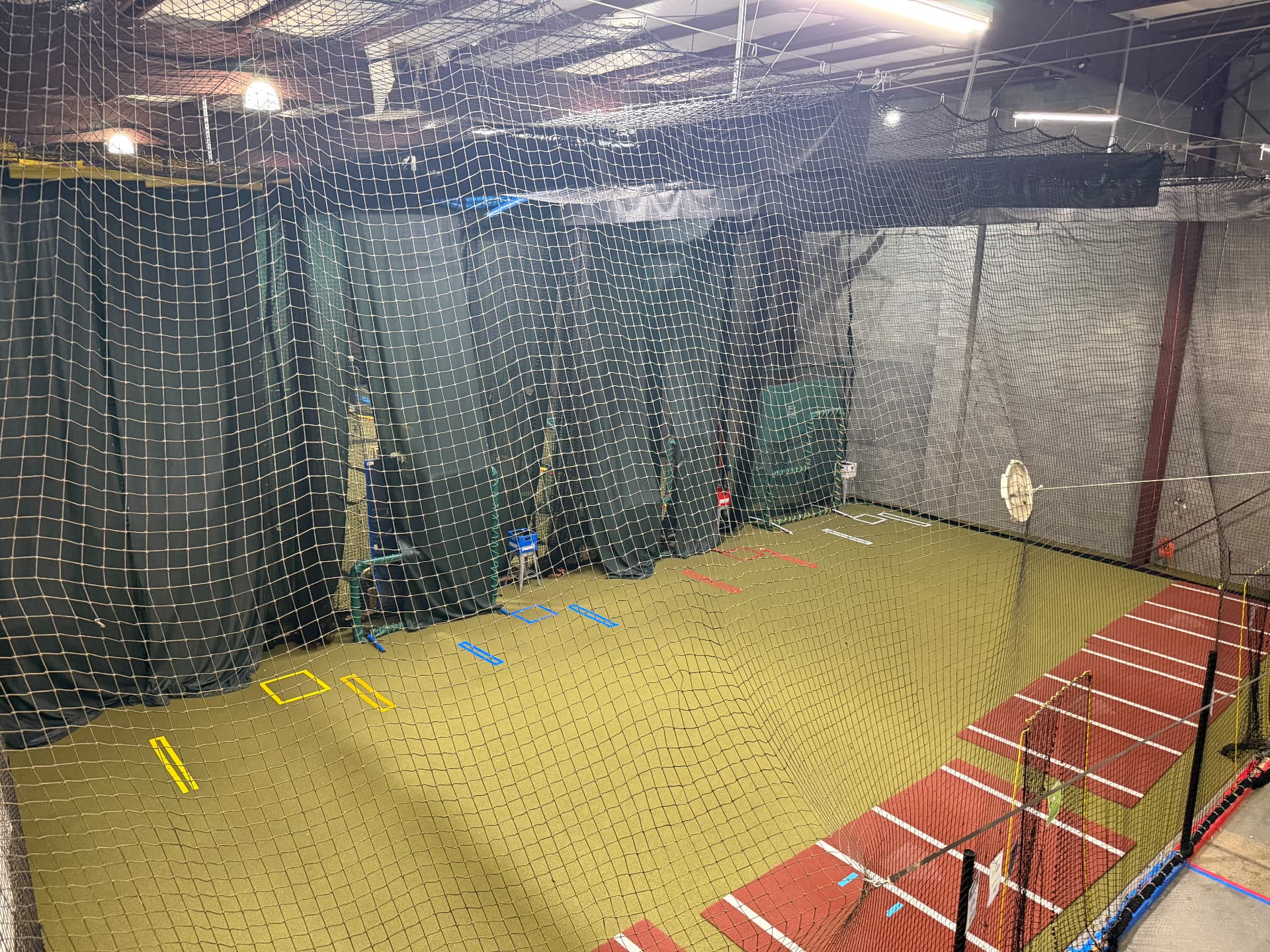 Wide mezzanine view of the JPLEX cage area and turf floor
