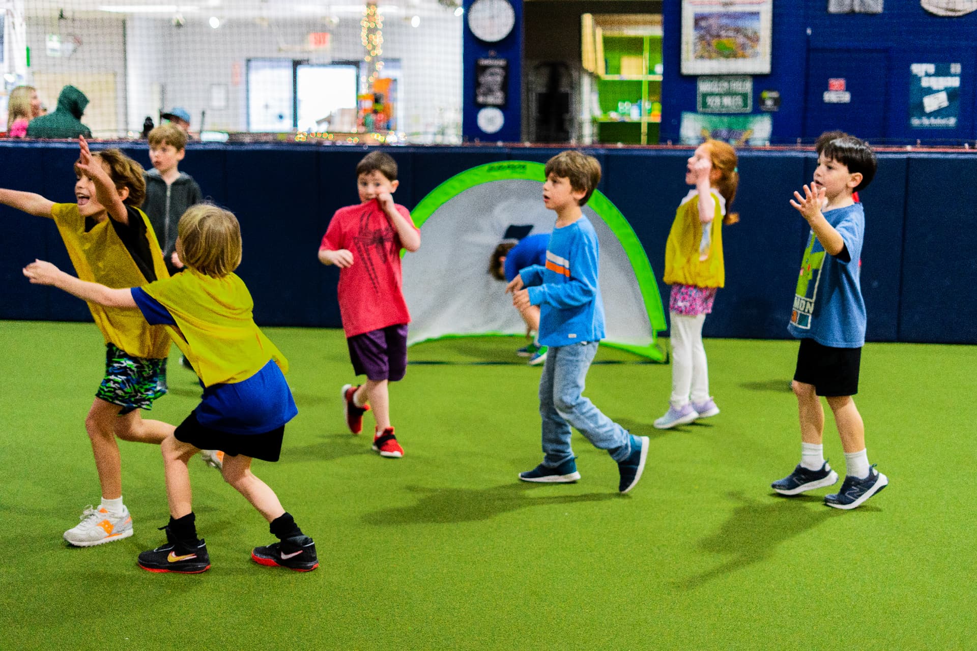 Campers celebrating together around a pop-up goal at JPLEX camp